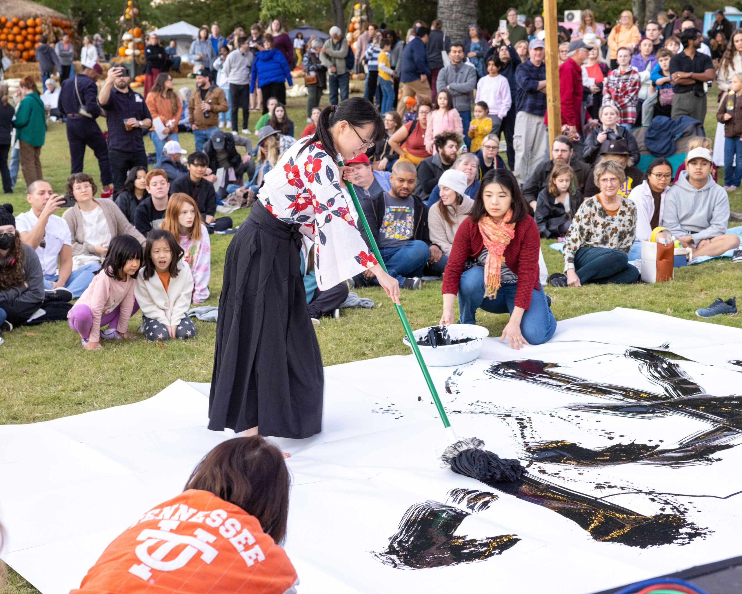Japanese Moon viewing event at Cheekwood Woman doing calligraphy