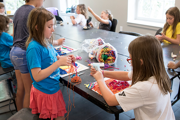Photo of kids working with textile materials during camp 2018