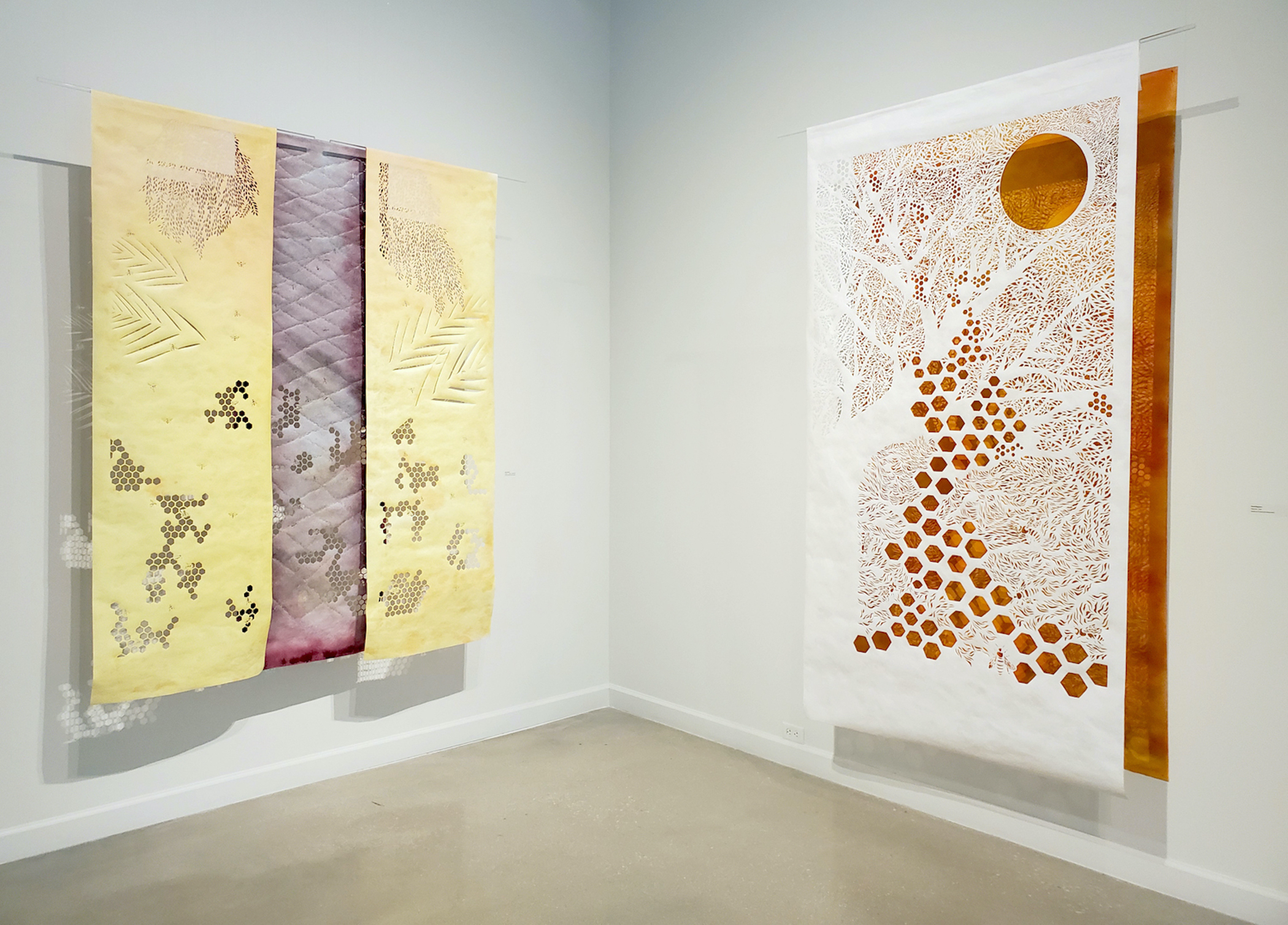 Sarah Nguyen. Install of Devorah Bee and Devorah- Songs of Judgement 76” H x 49” W Hand-cut Tyvek and wooden rod, spray painted paper. Photo courtesy of the Artist.